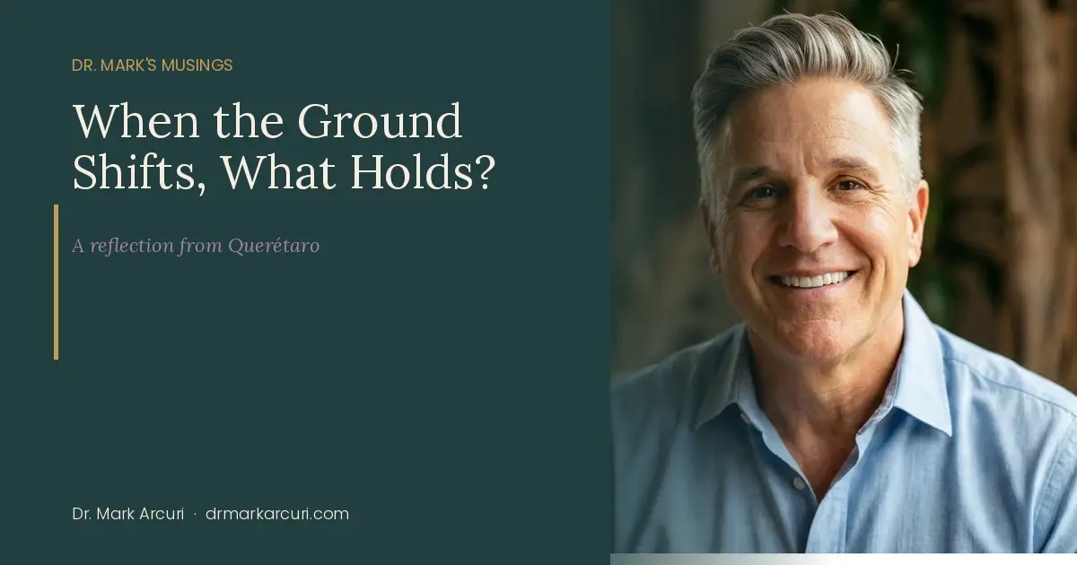 Dr. Mark Arcuri, psychologist and author, smiling in a warm interior setting — featured image for the blog post "When the Ground Shifts, What Holds?" on Dr. Mark's Musings